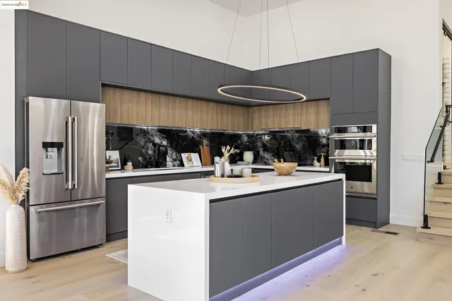 a living room with furniture and a kitchen