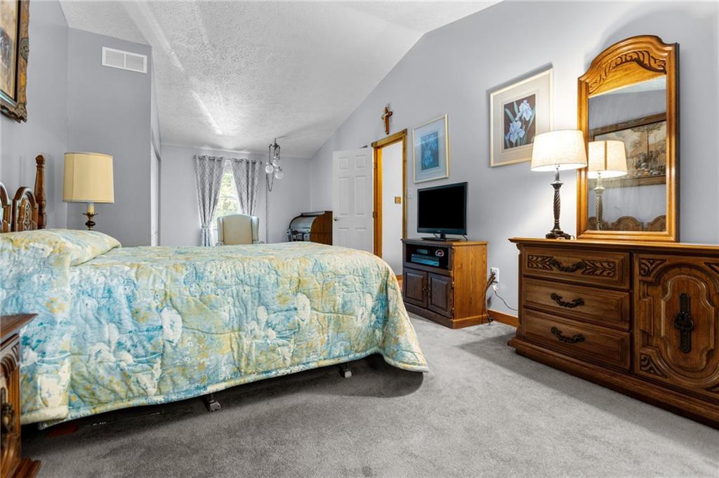 136 Lakeview Drive McKees Rocks, PA 15136 - Photo 16 of 24 a bedroom with a bed and a tv on dresser