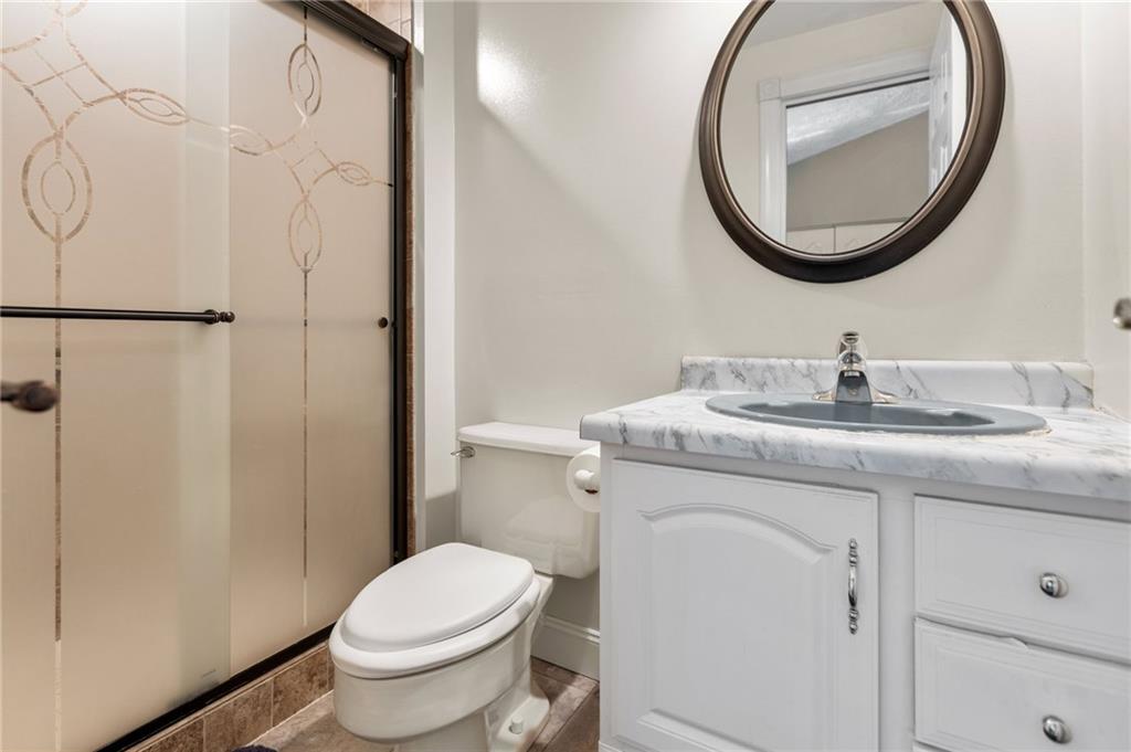 136 Lakeview Drive McKees Rocks, PA 15136 - Photo 17 of 24 a bathroom with a granite countertop toilet sink and mirror