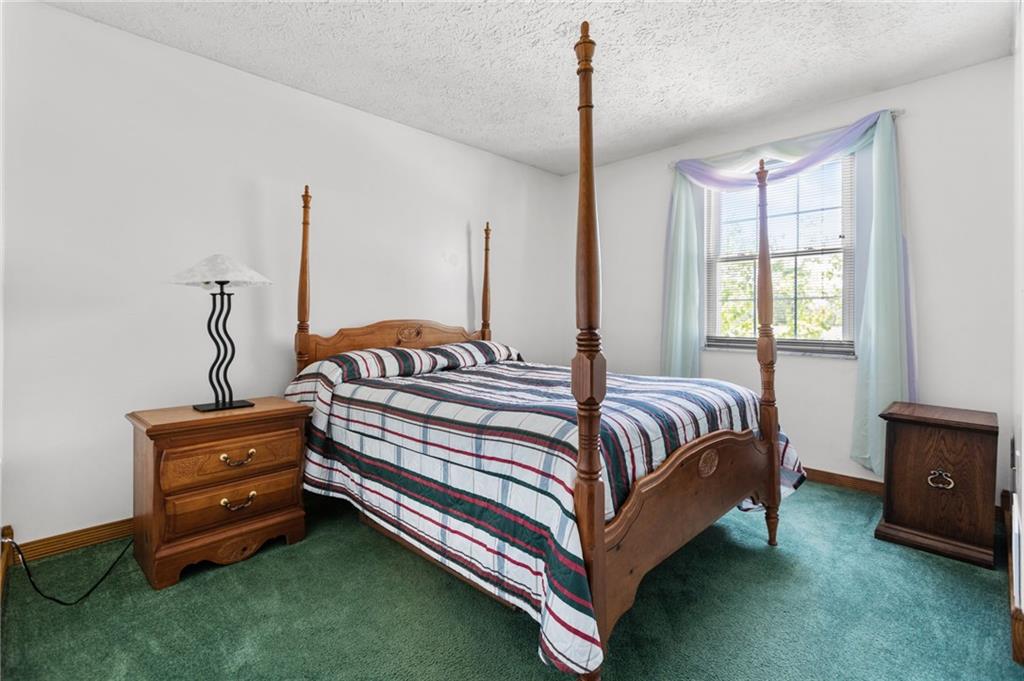 136 Lakeview Drive McKees Rocks, PA 15136 - Photo 19 of 24 a spacious bedroom with a bed and a window