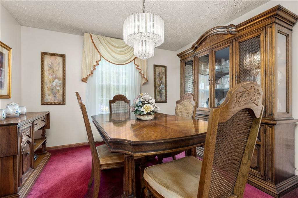 136 Lakeview Drive McKees Rocks, PA 15136 - Photo 5 of 24 a view of a dining room with furniture and a chandelier