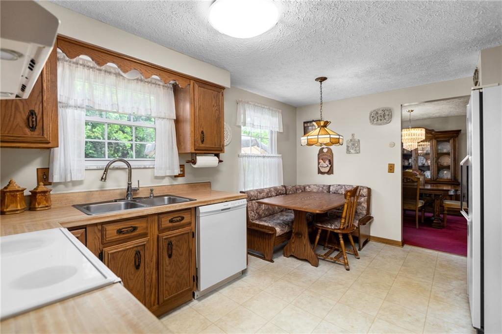 136 Lakeview Drive McKees Rocks, PA 15136 - Photo 7 of 24 a open kitchen with stainless steel appliances granite countertop sink stove and white cabinets
