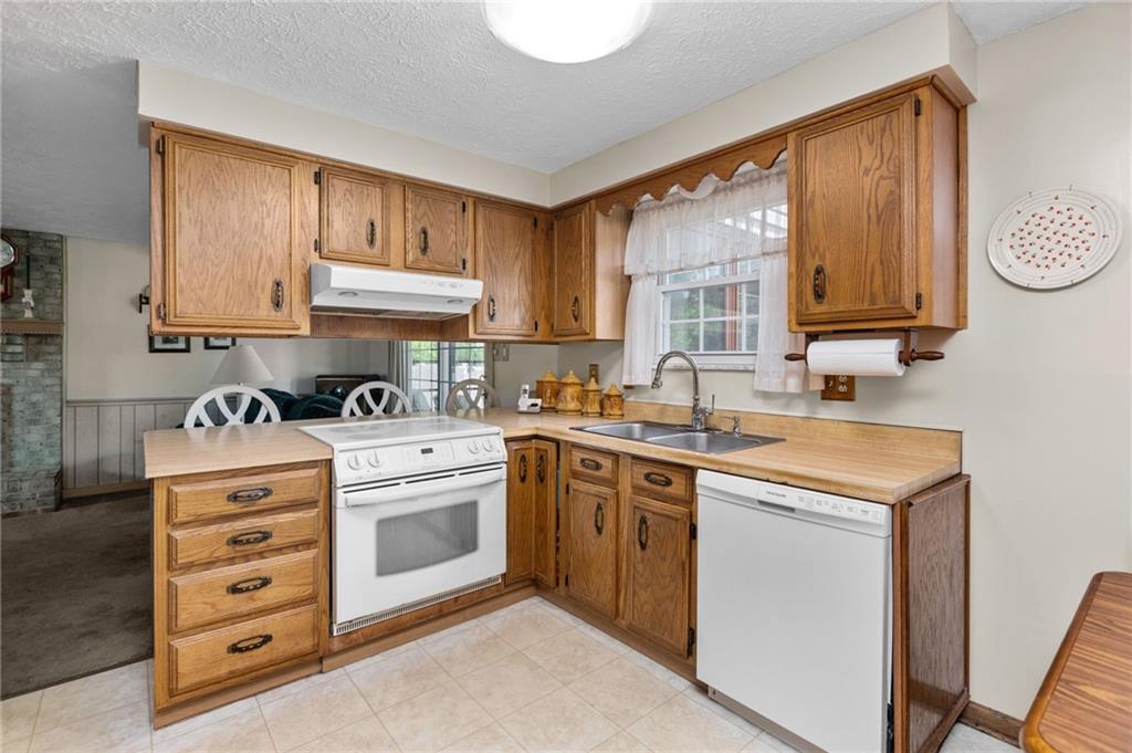 136 Lakeview Drive McKees Rocks, PA 15136 - Photo 8 of 24 a kitchen with granite countertop a sink cabinets stainless steel appliances and a window