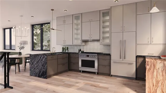 a kitchen with stainless steel appliances granite countertop a stove a sink and a refrigerator