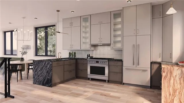 a kitchen with stainless steel appliances granite countertop a stove a sink and a refrigerator