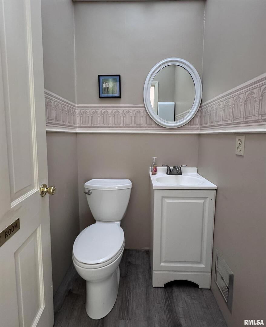 1415 4th Street Fulton, IL 61252 - Photo 32 of 58 a bathroom with a toilet sink and mirror