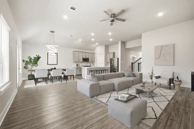 a living room with furniture and wooden floor