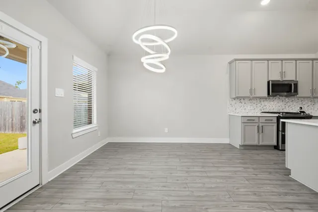 a view of a kitchen with a sink dishwasher and fireplace