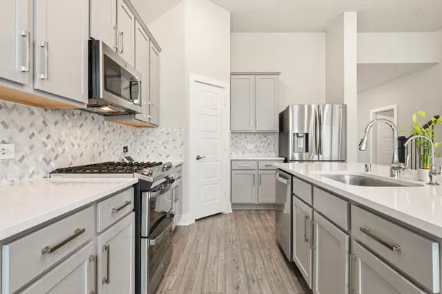 a kitchen with a sink stove and microwave