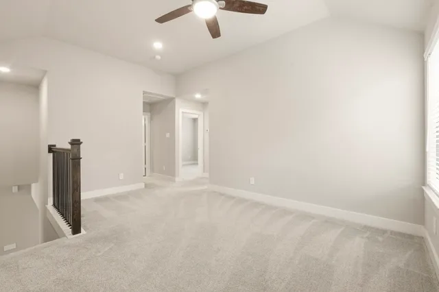 an empty room with a empty space and a ceiling fan