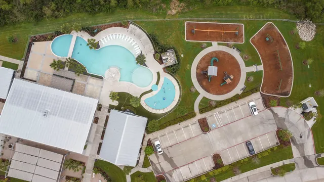 an aerial view of a house with outdoor space and swimming pool