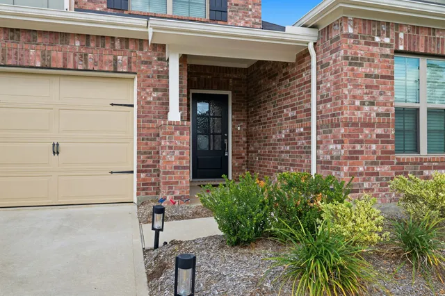 a view of a brick building with potted plants