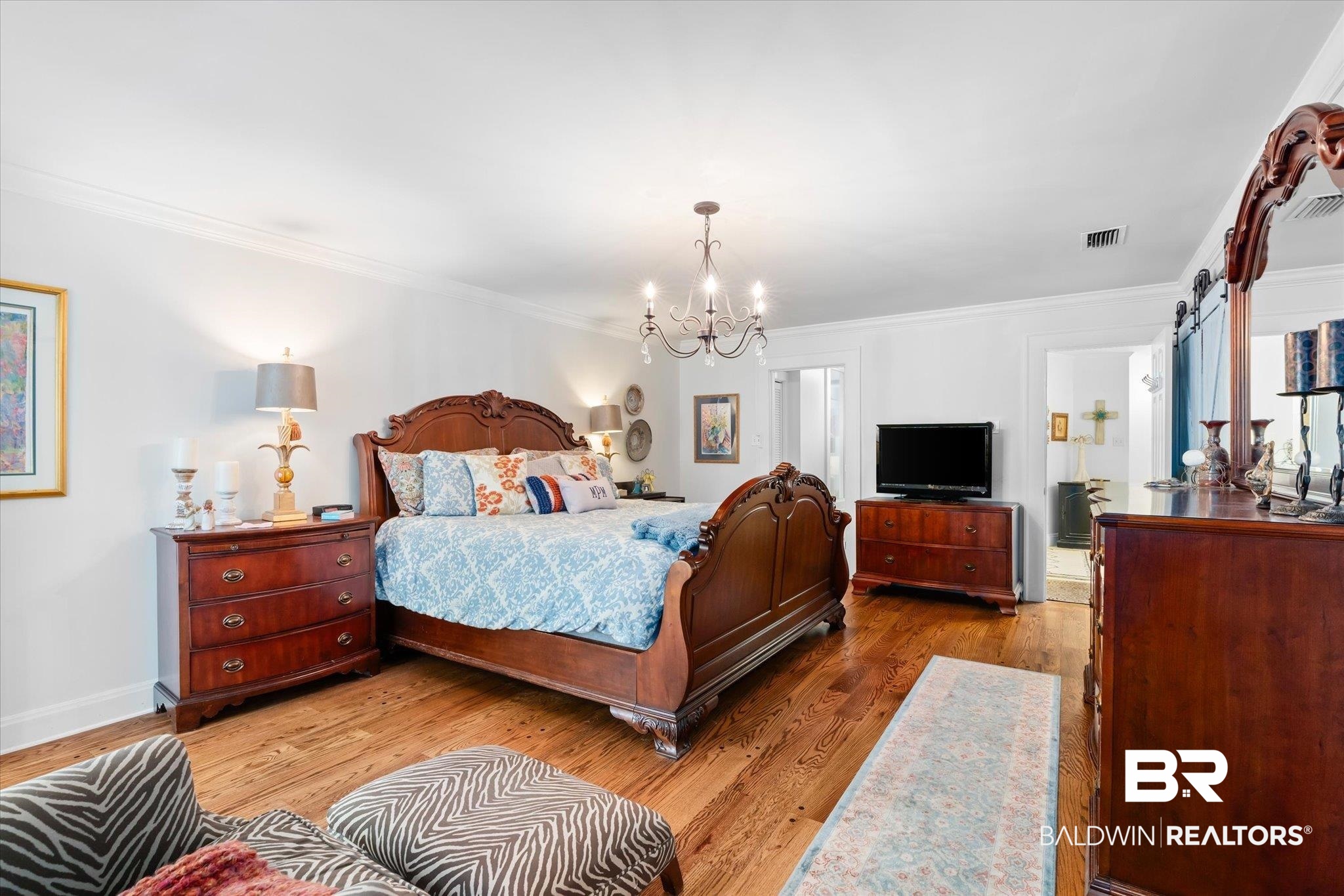 202 Woodlands Avenue Mobile, AL 36607 - Photo 15 of 53 Bedroom with crown molding, light hardwood / wood-style flooring, and a notable chandelier