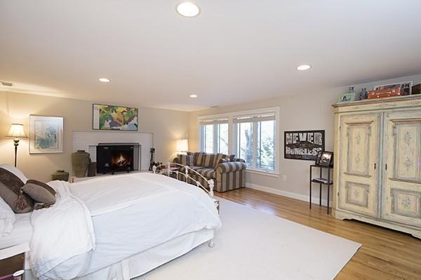 100 Westcliff Road Weston, MA 02493 - Photo 23 of 42 a large bedroom with a bed a table and wooden floor