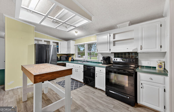 1090 South Hampton Road Hampton, GA 30228 - Photo 11 of 21 a kitchen with stainless steel appliances granite countertop a stove refrigerator sink and cabinets