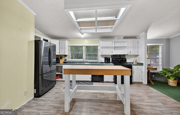 1090 South Hampton Road Hampton, GA 30228 - Photo 12 of 21 a kitchen with stainless steel appliances granite countertop a refrigerator and a stove top oven