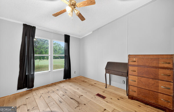1090 South Hampton Road Hampton, GA 30228 - Photo 14 of 21 a bedroom with a bed and a window
