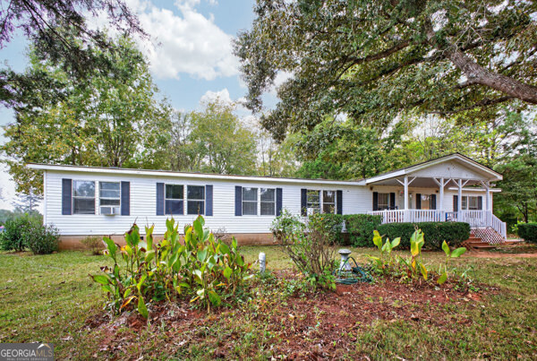 1090 South Hampton Road Hampton, GA 30228 - Photo 2 of 21 a view of a house with a big yard and potted plants