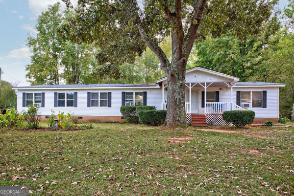 1090 South Hampton Road Hampton, GA 30228 - Photo 3 of 21 a front view of a house with a yard