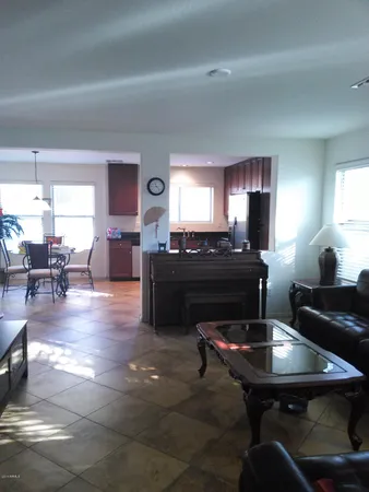 a kitchen with a table chairs a sink dishwasher and a fireplace