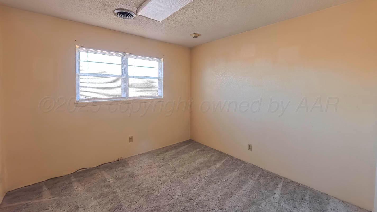 5015 Southwest 53rd Avenue Amarillo, TX 79109 - Photo 14 of 26 an empty room with a window
