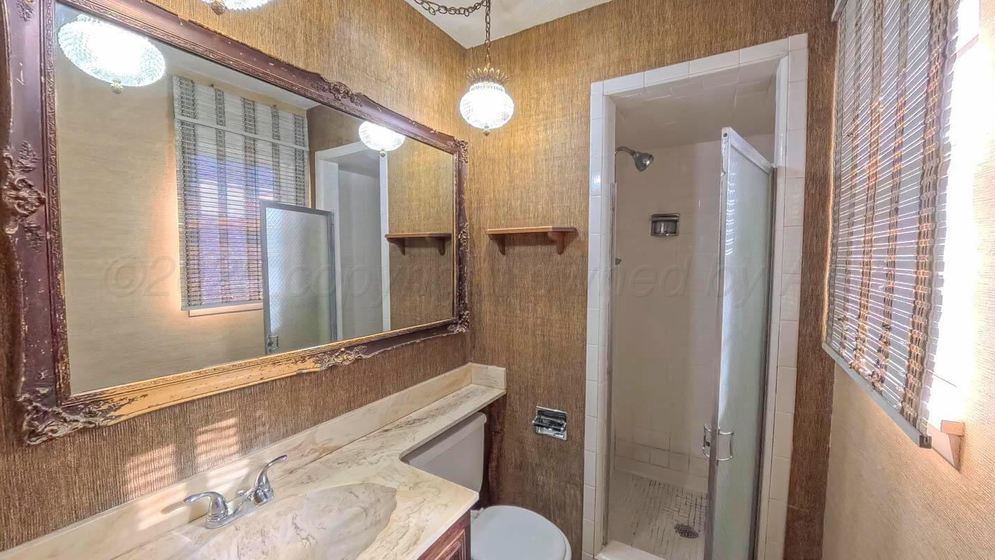 5015 Southwest 53rd Avenue Amarillo, TX 79109 - Photo 18 of 26 a bathroom with a bathtub and a sink
