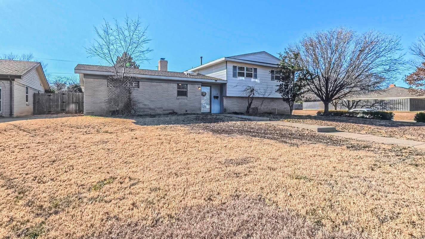 5015 Southwest 53rd Avenue Amarillo, TX 79109 - Photo 2 of 26 a front view of a house with a yard covered in snow