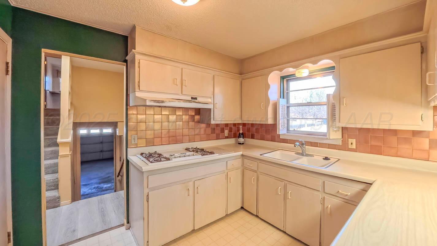 5015 Southwest 53rd Avenue Amarillo, TX 79109 - Photo 7 of 26 a utility room with cabinets washer and dryer