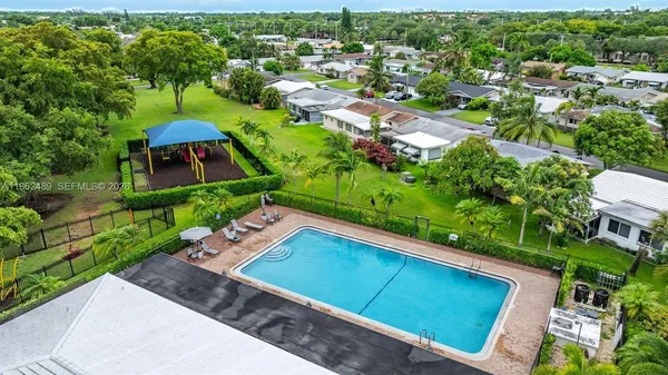 an aerial view of a house with a yard and lake view