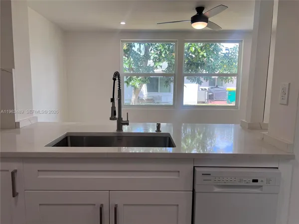 a kitchen with a sink and large window