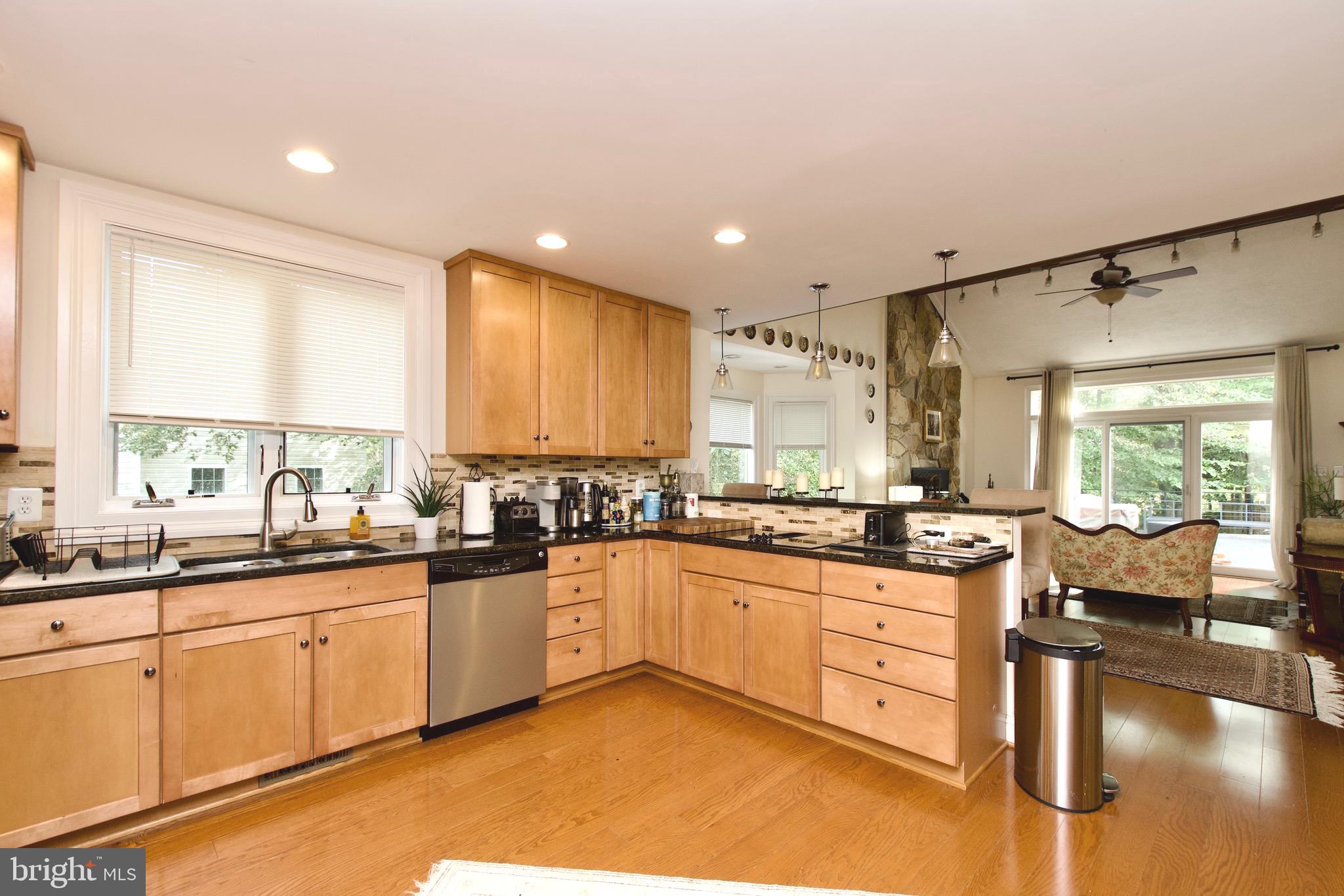 8312 Upper Spring Lane Annandale, VA 22003 - Photo 14 of 56 a large kitchen with granite countertop a sink and cabinets