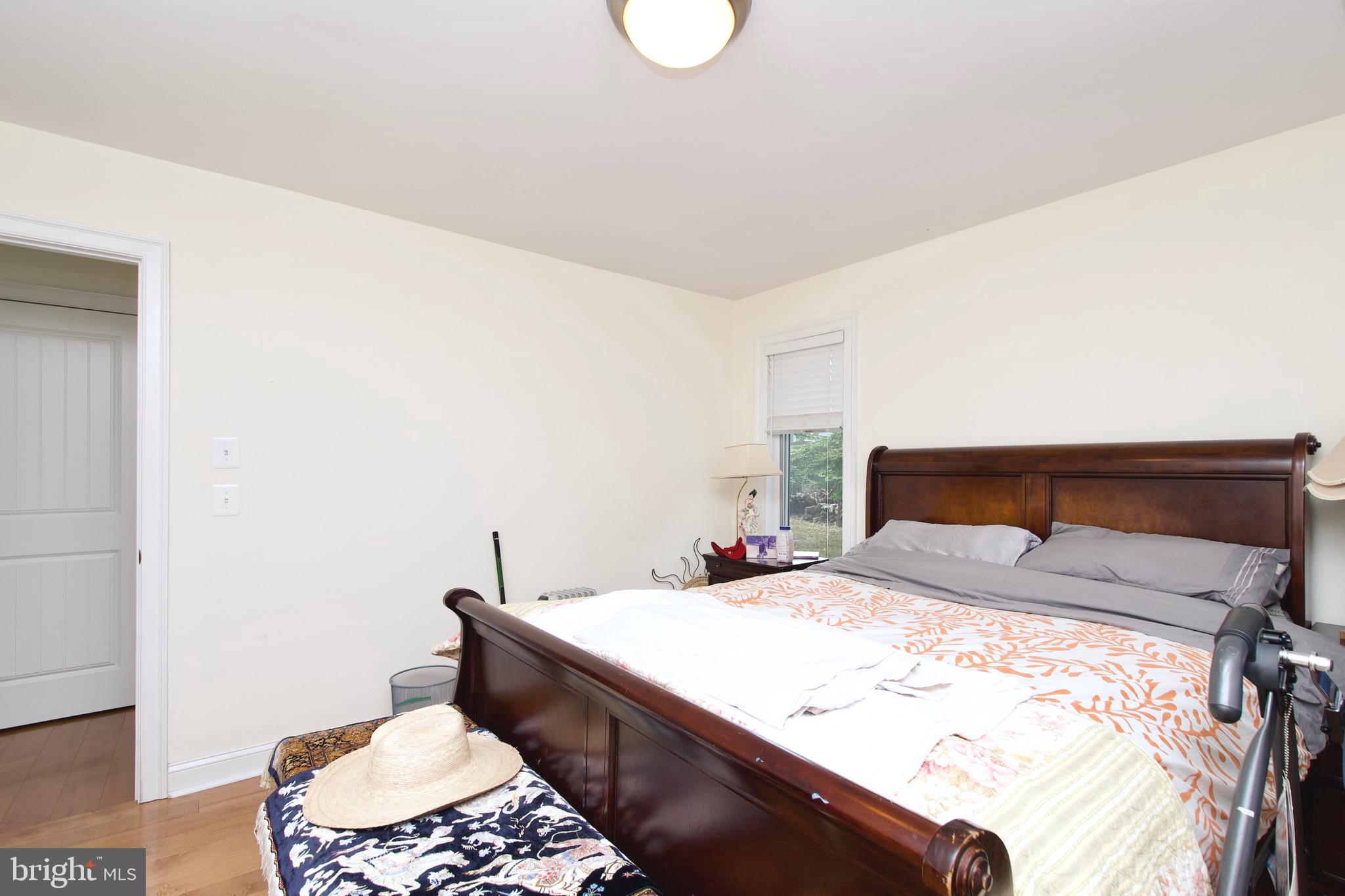 8312 Upper Spring Lane Annandale, VA 22003 - Photo 19 of 56 a bedroom with a bed and a lamp