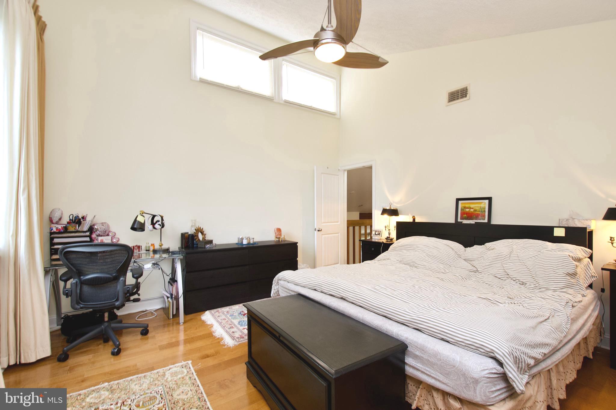 8312 Upper Spring Lane Annandale, VA 22003 - Photo 22 of 56 a bedroom with a bed and wooden floor