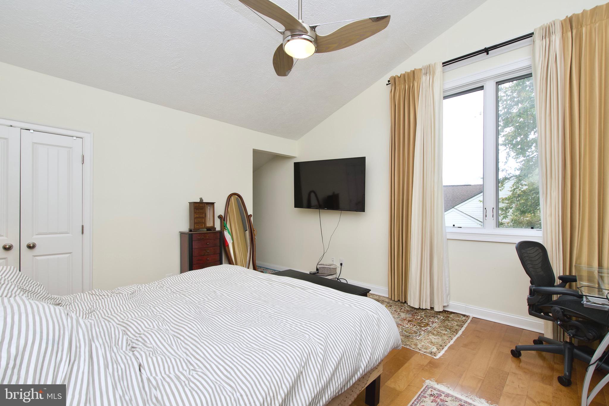 8312 Upper Spring Lane Annandale, VA 22003 - Photo 23 of 56 a bedroom with a bed and a flat screen tv