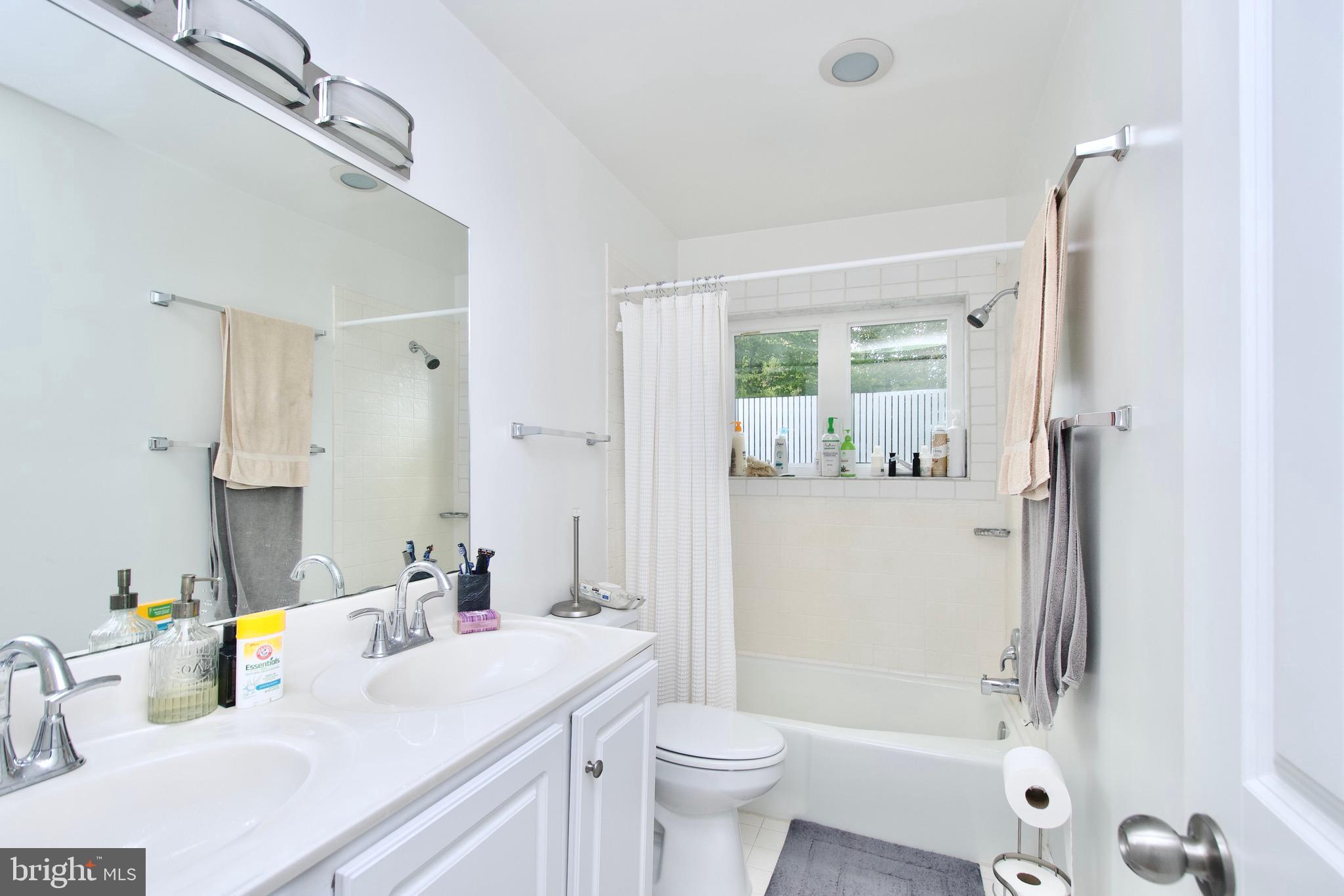 8312 Upper Spring Lane Annandale, VA 22003 - Photo 24 of 56 a bathroom with a sink a toilet and shower