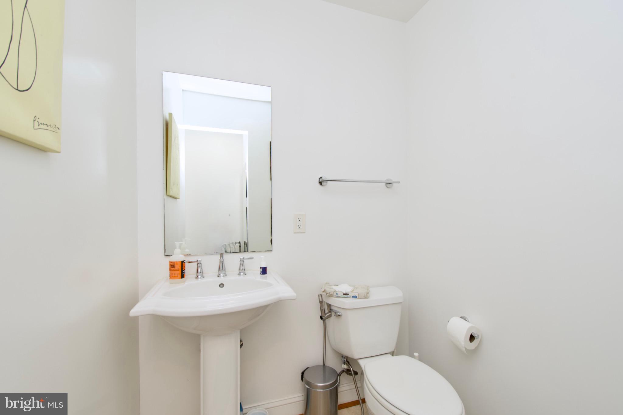 8312 Upper Spring Lane Annandale, VA 22003 - Photo 29 of 56 a bathroom with a sink mirror and toilet