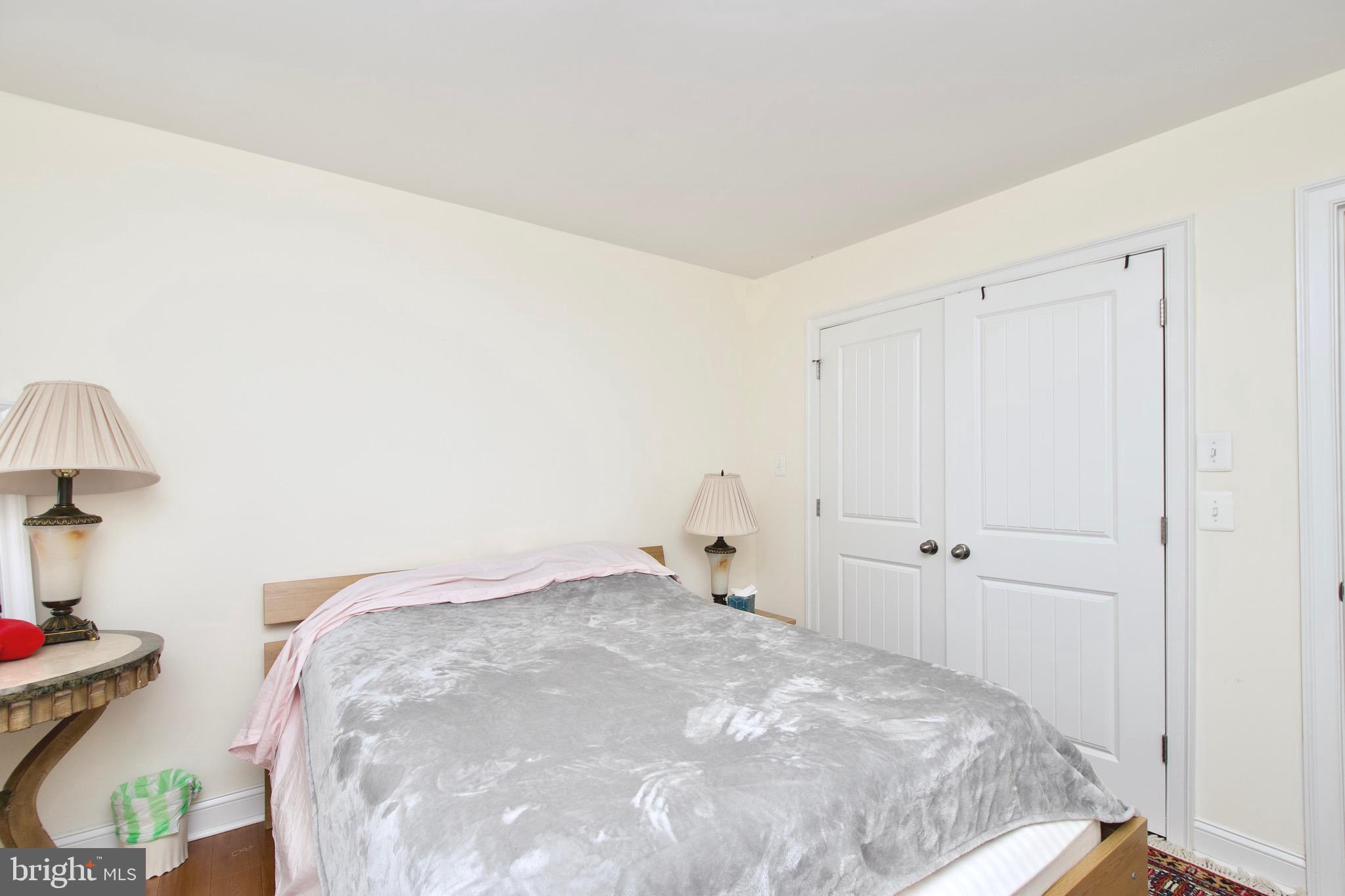 8312 Upper Spring Lane Annandale, VA 22003 - Photo 31 of 56 a bedroom with a bed and a lamp on table