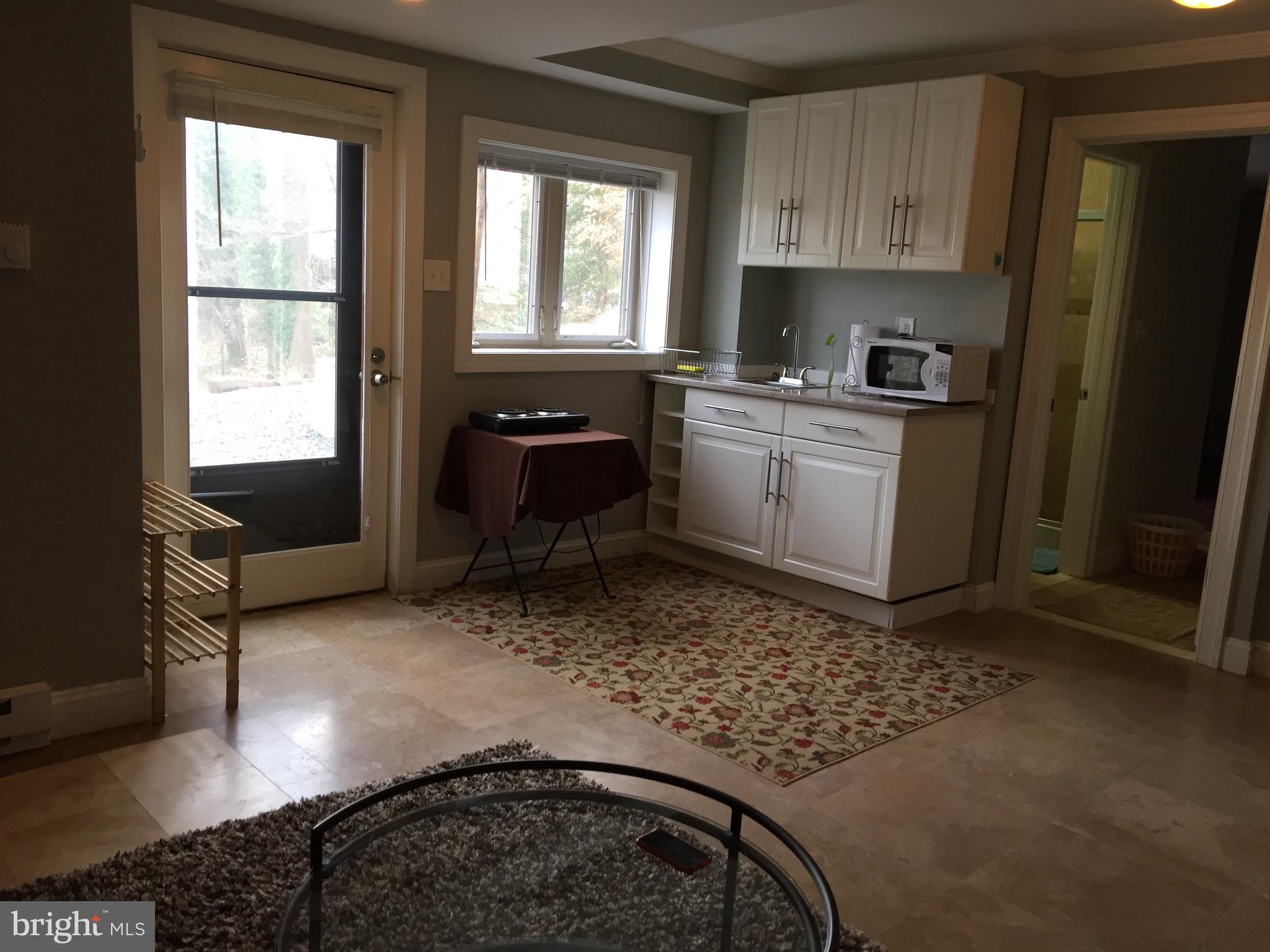 8312 Upper Spring Lane Annandale, VA 22003 - Photo 39 of 56 a kitchen with a stove a sink and a window