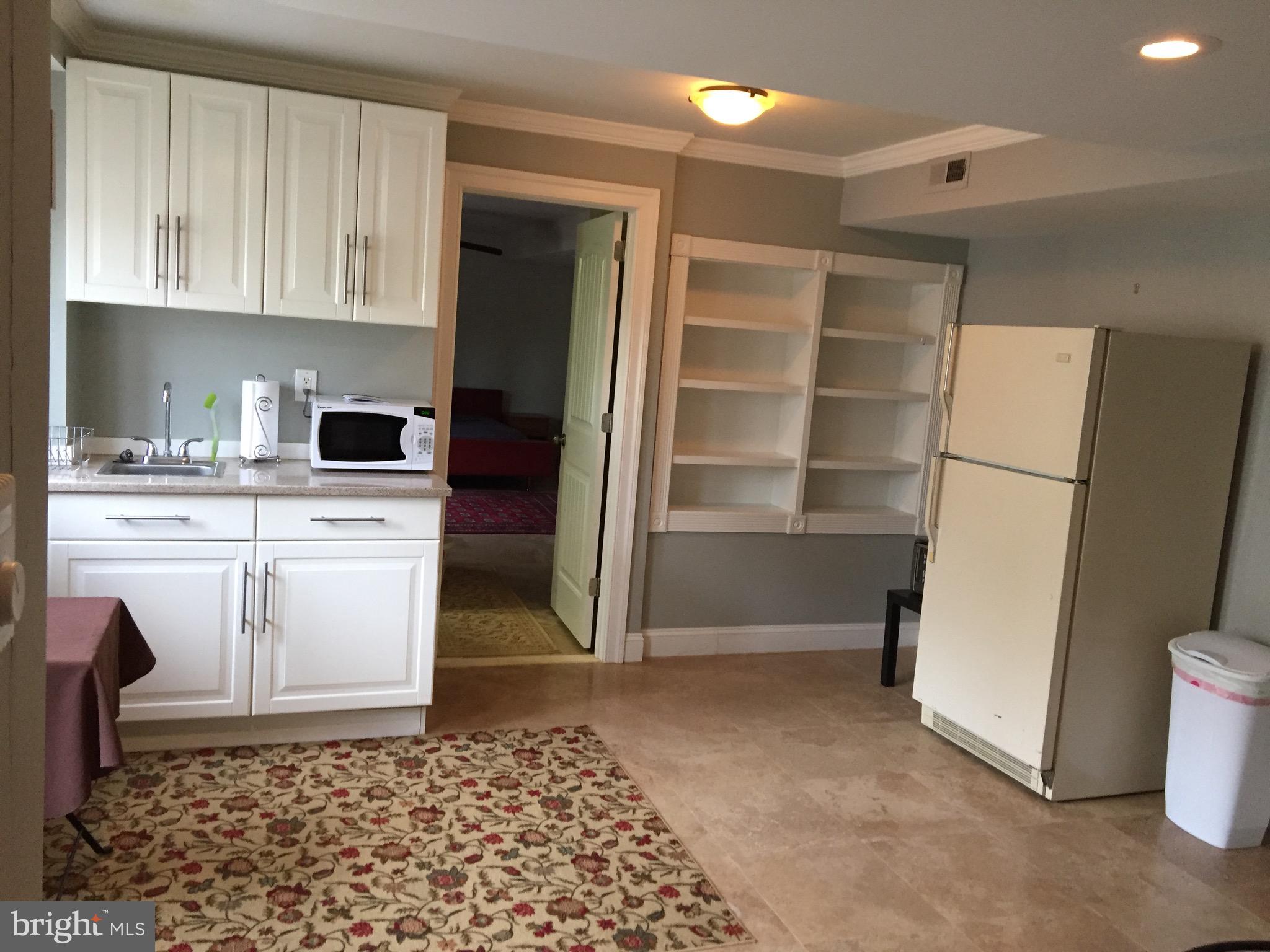 8312 Upper Spring Lane Annandale, VA 22003 - Photo 40 of 56 a kitchen with white cabinets and refrigerator