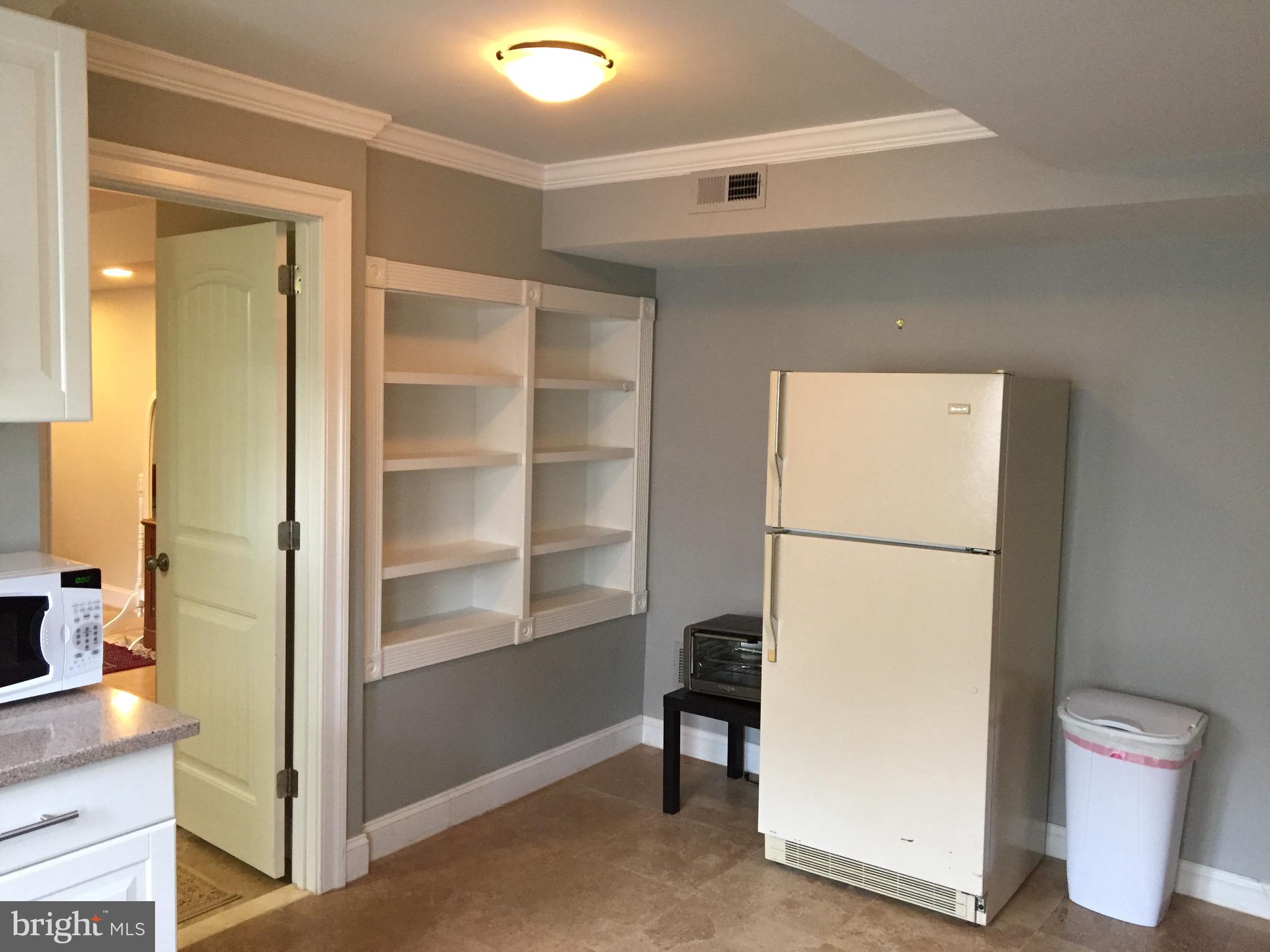 8312 Upper Spring Lane Annandale, VA 22003 - Photo 45 of 56 a view of a room with wooden floor and cabinet