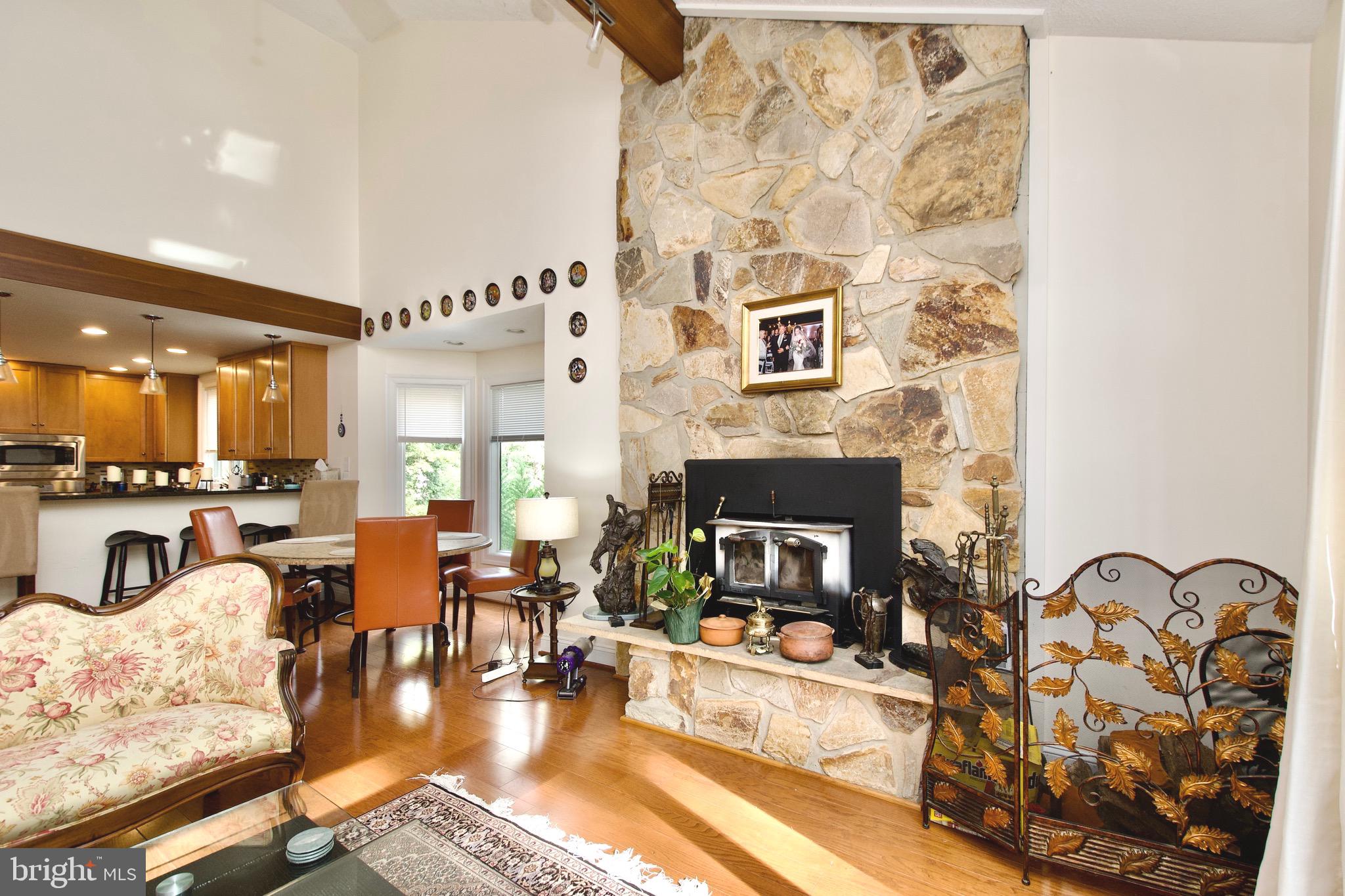 8312 Upper Spring Lane Annandale, VA 22003 - Photo 7 of 56 a living room with furniture fireplace and a fireplace