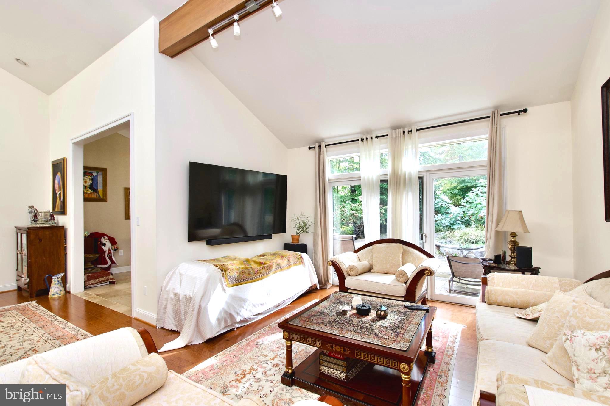 8312 Upper Spring Lane Annandale, VA 22003 - Photo 9 of 56 a living room with furniture a flat screen tv and a large window
