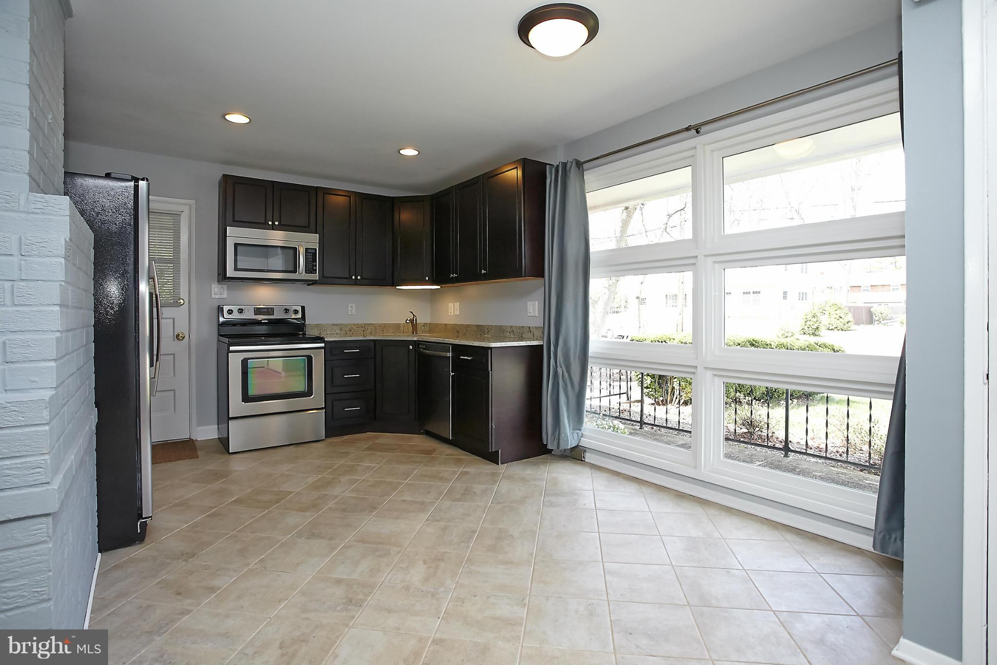 6717 Bostwick Drive Springfield, VA 22151 - Photo 2 of 12 a kitchen with stainless steel appliances granite countertop a refrigerator and a stove