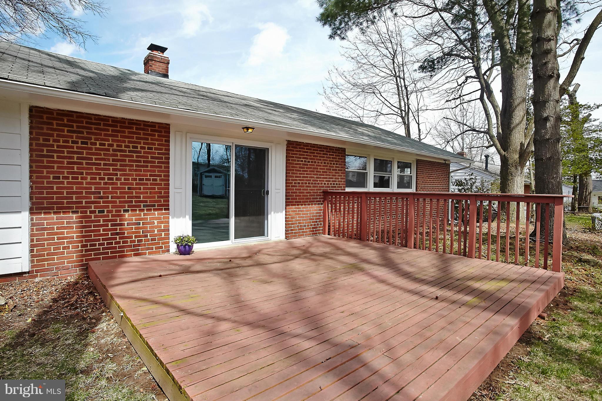 6717 Bostwick Drive Springfield, VA 22151 - Photo 11 of 12 a front view of a house with wooden floor and fence