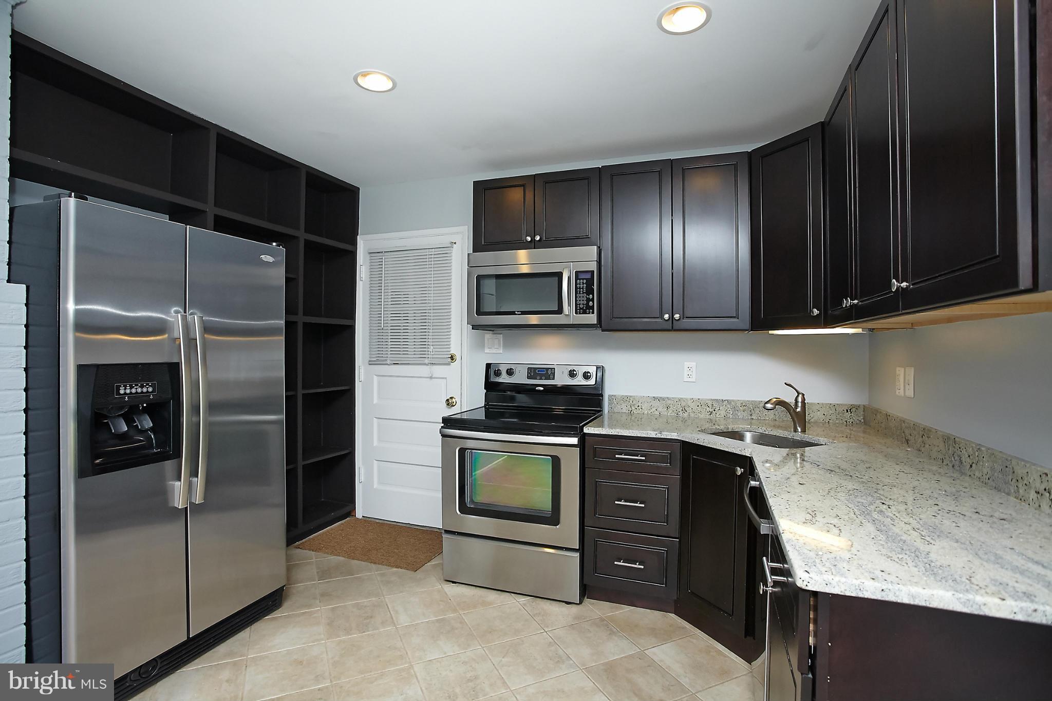 6717 Bostwick Drive Springfield, VA 22151 - Photo 4 of 12 a kitchen with a sink stove and refrigerator