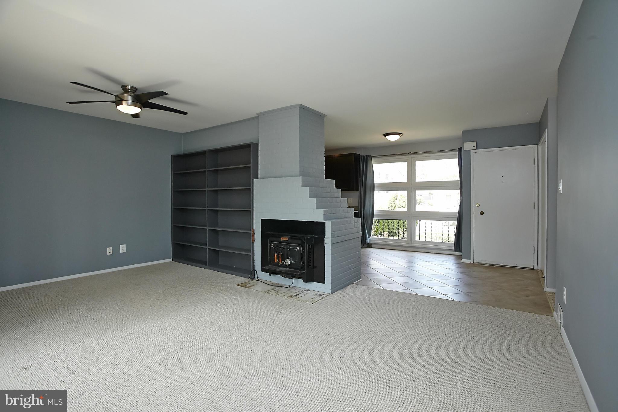 6717 Bostwick Drive Springfield, VA 22151 - Photo 5 of 12 wooden floor fireplace and windows in an empty room