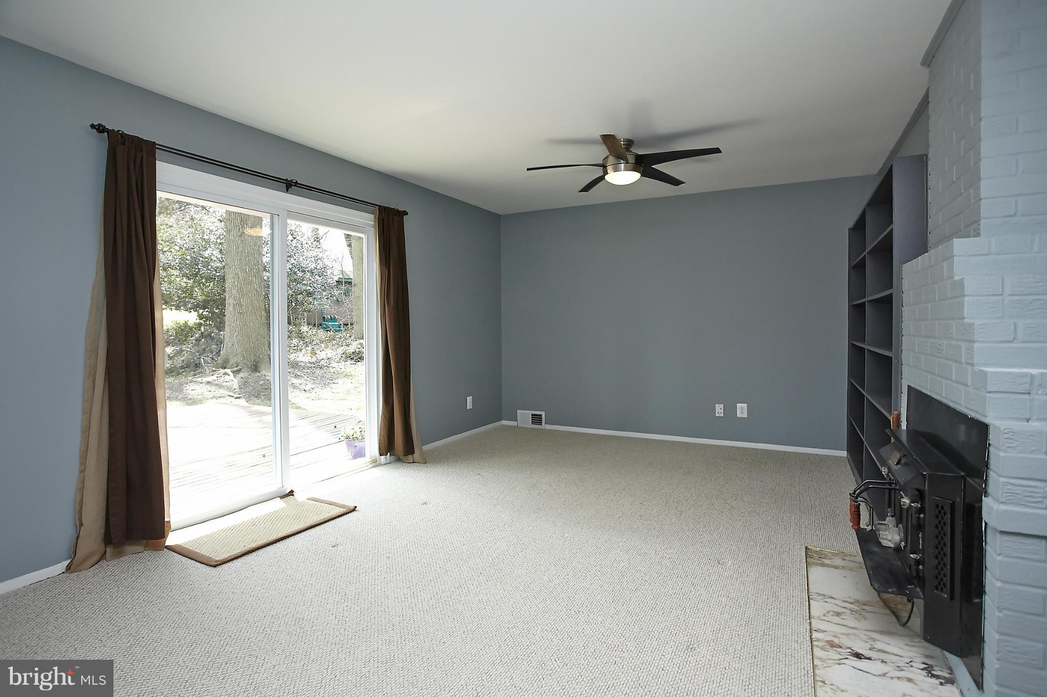 6717 Bostwick Drive Springfield, VA 22151 - Photo 6 of 12 a view of an empty room with a fireplace and a window