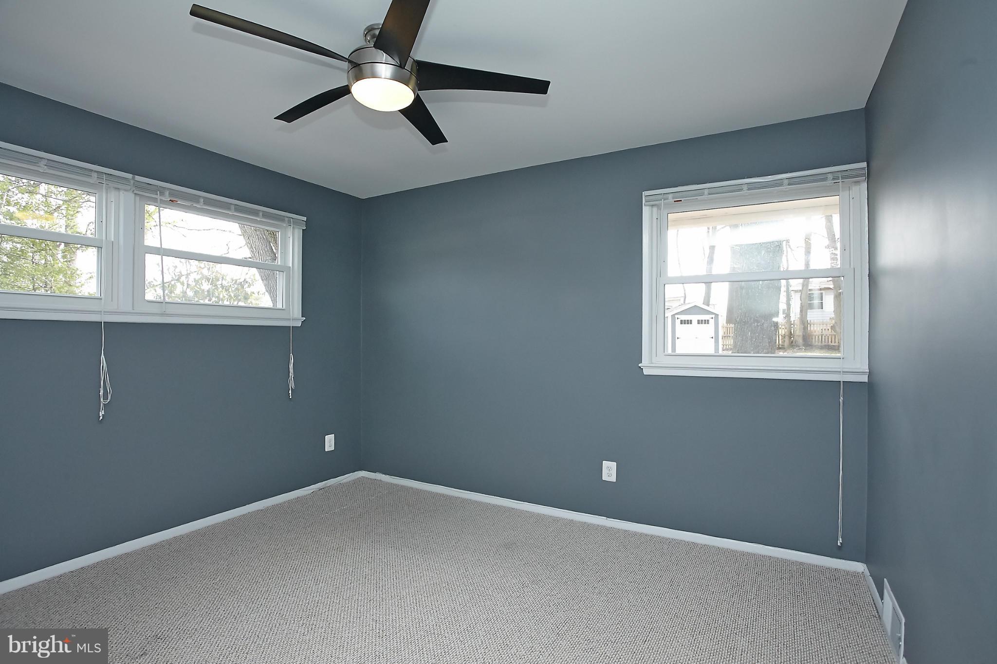 6717 Bostwick Drive Springfield, VA 22151 - Photo 8 of 12 an empty room with windows and fan