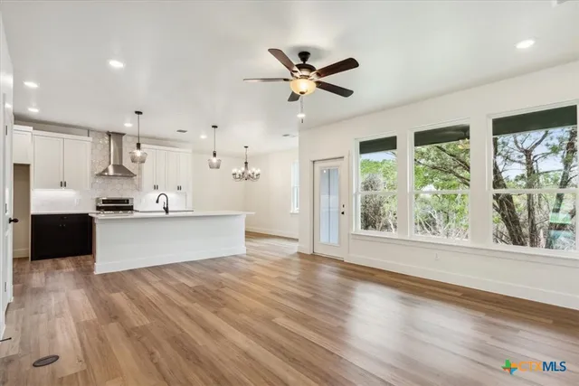 a view of a kitchen with wooden floor and a window