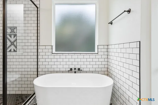 a white bath tub sitting in a bathroom